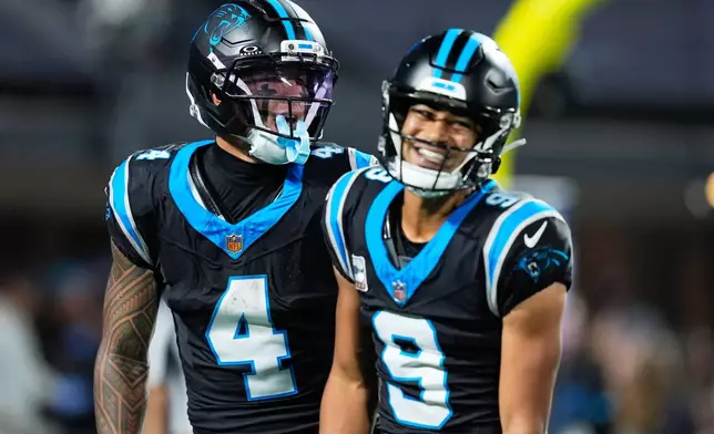 Carolina Panthers quarterback Bryce Young (9) and Carolina Panthers wide receiver Tetairoa McMillan (4) celebrate a touchdown during an NFL football game against the Detroit Lions in Charlotte, N.C., Sunday, Oct. 4, 2026. (AP Photo/Erik Verduzco)