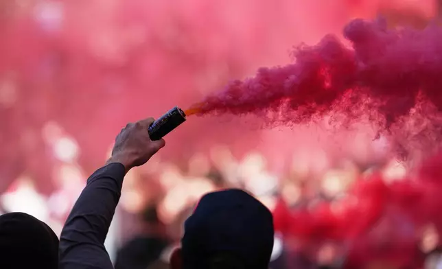 Liverpool fans light flares before the English Premier League soccer match between Liverpool and Manchester City in Liverpool, England, Sunday, Oct. 11, 2026. (AP Photo/Jon Super)