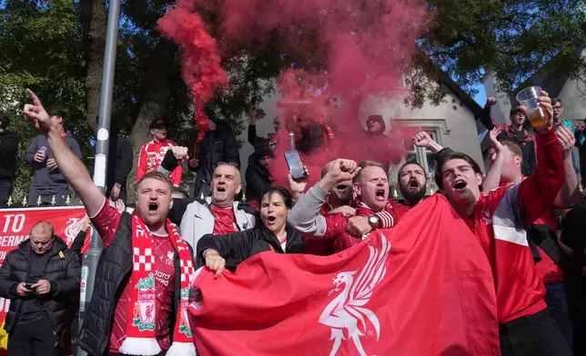 Liverpool fans light flares before the English Premier League soccer match between Liverpool and Manchester City in Liverpool, England, Sunday, Oct. 11, 2026. (AP Photo/Jon Super)