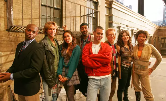 FILE - The cast of the film Rent, from left, Taye Diggs, Adam Pascal, Rosario Dawson, Jesse Martin, Wilson Jermaine Heredia, Anthony Rapp, Idina Menzel, and Tracie Thoms, pose for a on a film set in San Francisco on May 27, 2005. (AP Photo/Eric Risberg, File)