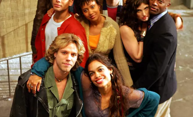 FILE - The cast of the film "Rent", front row from left, Adam Pascal, Rosario Dawson, second row from left, Wilson Jermaine Heredia, Tracie Thoms, Idina Menzel, and Taye Diggs, third row from left, Jesse Martin, and Anthony Rapp, pose for a photo on a film set in San Francisco on May 25, 2005. (AP Photo/Eric Risberg, File)
