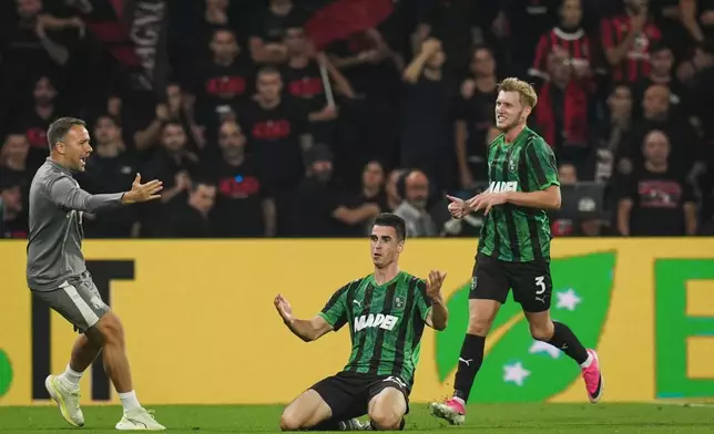 Sassuolo's Cas Odenthal celebrates after scoring during the Serie A soccer match between Sassuolo and AC Milan, in Reggio Emilia, Italy, Sunday, Oct.11, 2026. (Massimo Paolone/LaPresse via AP)