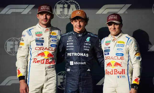 Pole winner Mercedes driver Kimi Antonelli, center, of Italy, poses with second place qualifier Red Bull driver Max Verstappen, left, of the Netherlands, and third place qualifier Red Bull driver Yuki Isack Hadjar, of France, followiing qualifying for the Formula One United States Grand Prix auto race in Austin, Texas, Saturday, Oct. 24, 2026. (Dustin Safranek/Pool Photo via AP)