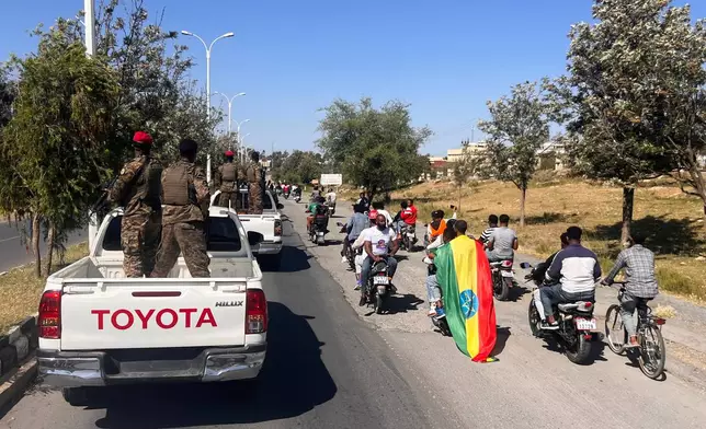 In this photo taken with a smartphone, supporters and soldiers participate in a procession welcoming former Tigray leader Getachew Reda in Mekelle, Ethiopia, Sunday, Oct. 11, 2026. (AP Photo/Filmon Equar Hailu)