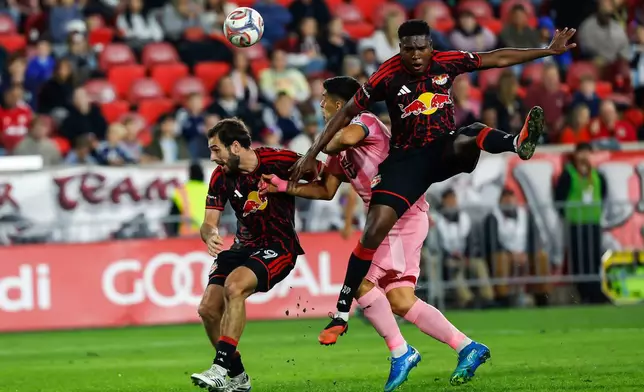 Inter Miami forward Luis Suarez, center, battles for the ball with New York Red Bulls defender Julian Bazan, right, and Devin Padelford during an MLS soccer match Saturday, Oct. 24, 2026, in Harrison, N.J. (AP Photo/Eduardo Munoz Alvarez)