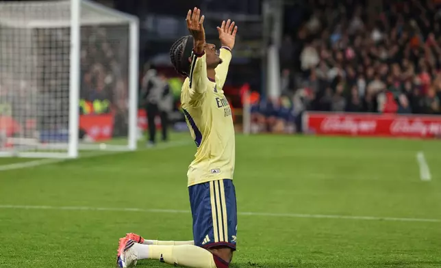Arsenal's Noni Madueke celebrates after scoring his side's opening goal during the English Premier League soccer match between Nottingham Forest and Arsenal in Nottingham, England, Sunday, Oct. 18, 2026. (AP Photo/Maddy Grassy)