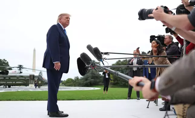 President Donald Trump listens as a reporter asks a question, before boarding Marine One on the South Lawn of the White House, Saturday, Oct. 3, 2026, in Washington. (AP Photo/Tom Brenner)