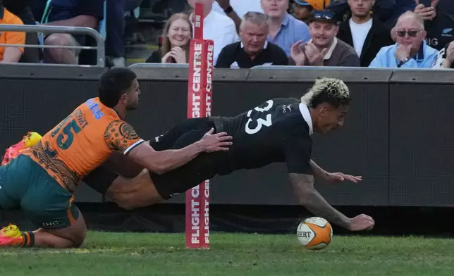 New Zealand's Rieko Ioane, right, scores a try against Australia's Tom Wright during the Bledisloe Cup rugby union test in Sydney, Saturday, Oct. 17, 2026. (AP Photo/Mark Baker)