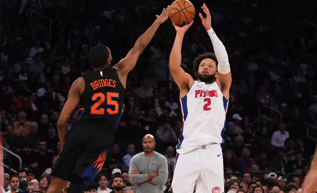 Detroit Pistons' Cade Cunningham (2) shoots over New York Knicks' Mikal Bridges (25) during the second half of an NBA basketball game Tuesday, Oct. 27, 2026, in New York. (AP Photo/Frank Franklin II)