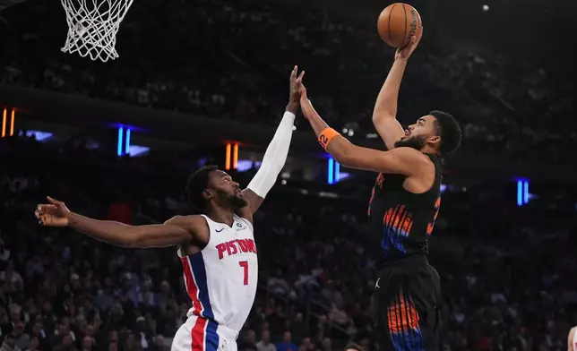 New York Knicks' Karl-Anthony Towns, right, shoots over Detroit Pistons' Paul Reed during the first half of an NBA basketball game Tuesday, Oct. 27, 2026, in New York. (AP Photo/Frank Franklin II)