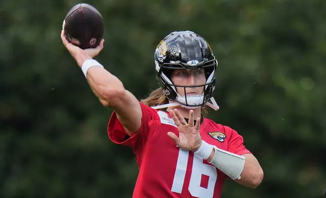 Jacksonville Jaguars' quarterback Trevor Lawrence (16) works out during an NFL football practice in Hertfordshire, England, Wednesday, Oct. 14, 2026. (AP Photo/Kin Cheung)