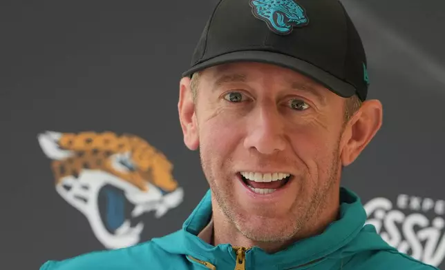 Jacksonville Jaguars head coach Liam Coen speaks to the media before an NFL football practice in Hertfordshire, England, Wednesday, Oct. 14, 2026. (AP Photo/Kin Cheung)