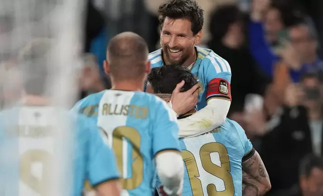 Argentina's Nicolas Otamendi, 19, celebrates with teammate Argentina's Lionel Messi after scoring his side's opening goal, during Messi's final match for the national team, a soccer friendly against Benin, in Buenos Aires, Argentina, Tuesday, Oct.6, 2026. (AP Photo/Gustavo Garello)