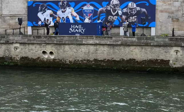 A fan participates in the Hail Mary event on the banks of the Seine river in Paris, Friday, Oct. 23, 2026 in the build up to the Saints against Steelers NFL game. (AP Photo/Dave Shopland)