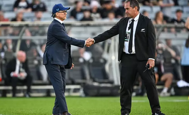 New Zealand All Blacks' coach Dave Rennie, right, and Australia's head coach Les Kiss shake hands before playing in a Bledisloe Cup rugby union test match in Auckland, New Zealand on Saturday, Oct. 10 2026. (Andrew Cornaga/Photosport via AP)