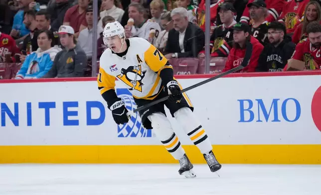 Pittsburgh Penguins center Evgeni Malkin reacts during the second period of an NHL hockey game against the Chicago Blackhawks, Tuesday, Oct. 13, 2026, in Chicago. (AP Photo/Harry Figiel)