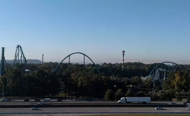 Attractions are seen near Interstate-20 at Six Flags Over Georgia, about 15 miles (24 kilometers) northwest of Atlanta, Tuesday, Oct. 13, 2026. (AP Photo/Mike Stewart)