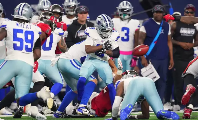 Dallas Cowboys' Kavontae Turpin (9) fumbles the ball on a kickoff return and the Tampa Bay Buccaneers recover in the second half of an NFL football game in Arlington, Texas on Thursday, Oct. 8, 2026. (AP Photo/Julio Cortez)