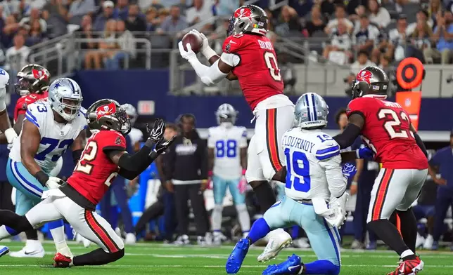 Tampa Bay Buccaneers linebacker Yaya Diaby (0) intercepts a pass against the Dallas Cowboys in the second half of an NFL football game in Arlington, Texas on Thursday, Oct. 8, 2026. (AP Photo/Julio Cortez)