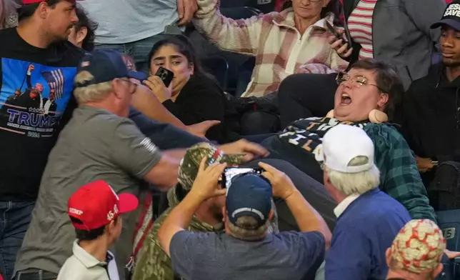 A protester yells before being removed as President Donald Trump speaks at a campaign rally at the Covelli Centre, in Youngstown, Ohio, Monday, Oct. 12, 2026. (AP Photo/Jacquelyn Martin)