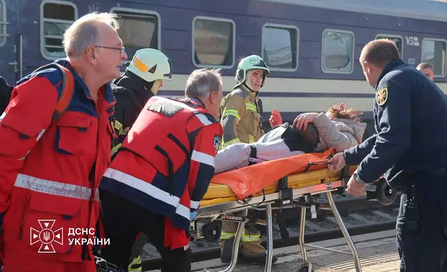 In this photo provided by the Ukrainian Emergency Service, rescuers evacuate a wounded civilian after a Russian drone attack on a railway platform in Dnipro, Ukraine, Thursday, Oct. 29, 2026. (Ukrainian Emergency Service via AP)