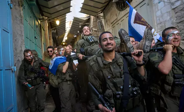 Soldiers from the ultra-Orthodox Hashmonaim Brigade march through Jerusalem's Old City at the conclusion of initial training before receiving their unit berets, Thursday, Aug. 6, 2026. (AP Photo/Ohad Zwigenberg)