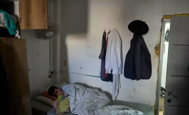 An Ultra-Orthodox Jewish seminary student rests in his room at midday at Ponevezh, Israel’s most prominent yeshiva, or seminary, in Bnei Brak, Israel, Wednesday, Feb. 11, 2026. (AP Photo/Ohad Zwigenberg)