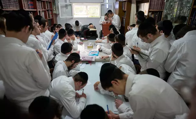 Ultra-Orthodox Jewish seminary students listen to their rabbi at Ponevezh Yeshiva in Bnei Brak, Israel, Wednesday, May 6, 2026. (AP Photo/Ohad Zwigenberg)