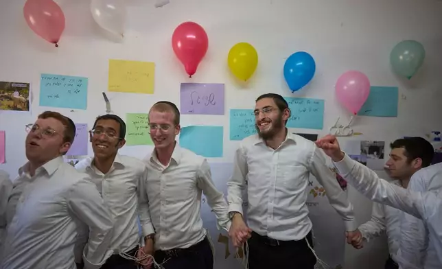 Ultra-Orthodox Jewish seminary students celebrate the engagement of their friend Eliezer Shetzigal inside Ponevezh, Israel’s most prominent yeshiva, or seminary, in Bnei Brak, Israel, Tuesday, June 9, 2026. (AP Photo/Ohad Zwigenberg)