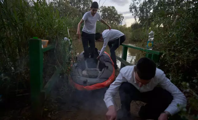 Ultra-Orthodox Jewish seminary students from Slabodka Yeshiva spend time at Yarkon Park during their term break, known as bein hazmanim, in Tel Aviv, Israel, Monday, March 30, 2026. (AP Photo/Ohad Zwigenberg)