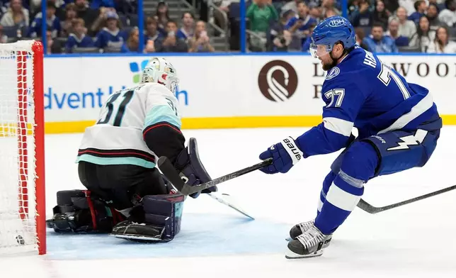Tampa Bay Lightning defenseman Victor Hedman (77) scores past Seattle Kraken goaltender Philipp Grubauer (31) during overtime of an NHL hockey game Thursday, Oct. 15, 2026, in Tampa, Fla. (AP Photo/Chris O'Meara)