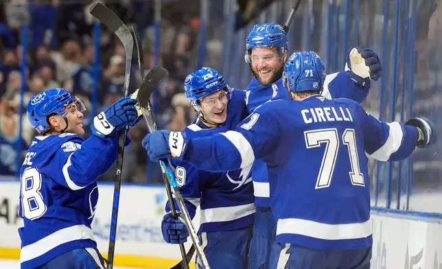 Tampa Bay Lightning defenseman Victor Hedman, second from right, celebrates with teammates after scoring the game-winning goal against the Seattle Kraken during overtime of an NHL hockey game Thursday, Oct. 15, 2026, in Tampa, Fla. (AP Photo/Chris O'Meara)