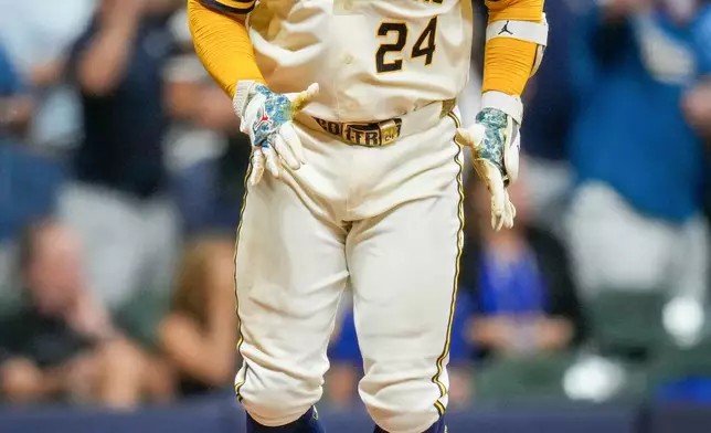 Milwaukee Brewers catcher William Contreras celebrates his RBI base hit during the sixth inning of Game 2 of baseball's National League Championship Series between the Milwaukee Brewers and the Los Angeles Dodgers, Monday, Oct. 12, 2026, in Milwaukee.(AP Photo/Ashley Landis)