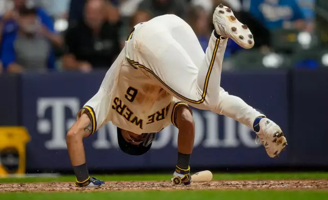 Milwaukee Brewers third baseman David Hamilton falls after being hit by a pitch during the sixth inning of Game 2 of baseball's National League Championship Series between the Milwaukee Brewers and the Los Angeles Dodgers, Monday, Oct. 12, 2026, in Milwaukee. (AP Photo/Ashley Landis)