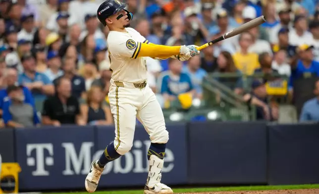 Milwaukee Brewers catcher William Contreras follows through on his solo home run during the fifth inning of Game 2 of baseball's National League Championship Series between the Milwaukee Brewers and the Los Angeles Dodgers, Monday, Oct. 12, 2026, in Milwaukee. (AP Photo/Ashley Landis)
