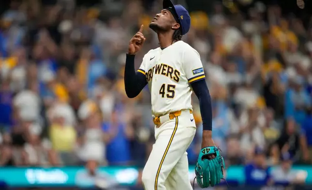 Milwaukee Brewers pitcher Abner Uribe walks to the dugout during the seventh inning of Game 2 of baseball's National League Championship Series between the Milwaukee Brewers and the Los Angeles Dodgers, Monday, Oct. 12, 2026, in Milwaukee. (AP Photo/Ashley Landis)