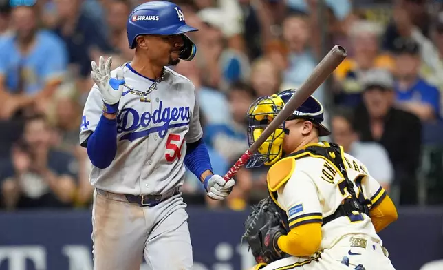Los Angeles Dodgers shortstop Mookie Betts (50) reacts after striking out during the eighth inning of Game 2 of baseball's National League Championship Series between the Milwaukee Brewers and the Los Angeles Dodgers, Monday, Oct. 12, 2026, in Milwaukee. (AP Photo/Abbie Parr)