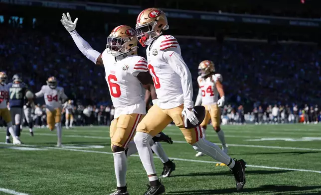 San Francisco 49ers safety Malik Mustapha (6) and cornerback Renardo Green (0) react after an interception against the Seattle Seahawks during the first half of an NFL football game Sunday, Oct. 11, 2026, in Seattle. (AP Photo/Lindsey Wasson)