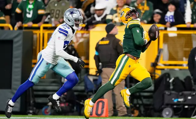 Green Bay Packers' Matthew Golden drops a pass in front of Dallas Cowboys' Ameer Speed during the first half of an NFL football game in Green Bay, Wis., Sunday, Oct. 18, 2026. (AP Photo/Nam Huh)