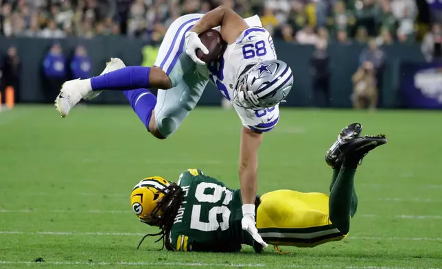 Green Bay Packers' Ty'ron Hopper stops Dallas Cowboys' Brevyn Spann-Ford during the second half of an NFL football game in Green Bay, Wis., Sunday, Oct. 18, 2026. (AP Photo/Matt Ludtke)