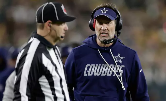 Dallas Cowboys head coach Brian Schottenheimer argues a call during the first half of an NFL football game against the Green Bay Packers in Green Bay, Wis., Sunday, Oct. 18, 2026. (AP Photo/Matt Ludtke)