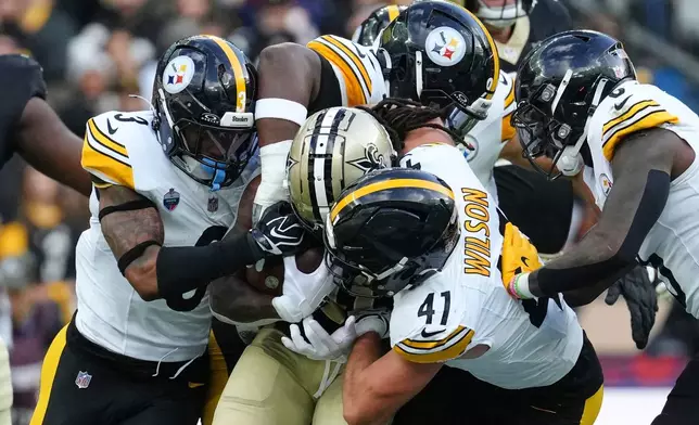 New Orleans Saints running back Alvin Kamara (41) is tackled during an NFL football game against Pittsburgh Steelers in Saint-Denis, outside Paris, Sunday, Oct. 25, 2026. (AP Photo/Aurelien Morissard)