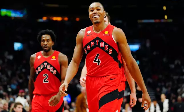 Toronto Raptors' Scottie Barnes (4) smiles as he walks off the court at the end of first half NBA basketball action against the Chicago Bulls in Toronto on Wednesday, Oct. 21, 2026. (Frank Gunn/The Canadian Press via AP)
