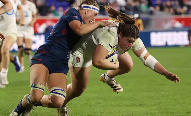 United States' Georgie Perris-Redding, left, tackles England's Maud Muir, right, during the second half of an international women's rugby match during the WXV Global Series, Friday, Oct. 30, 2026, in Harrison, N.J. (AP Photo/Pamela Smith)