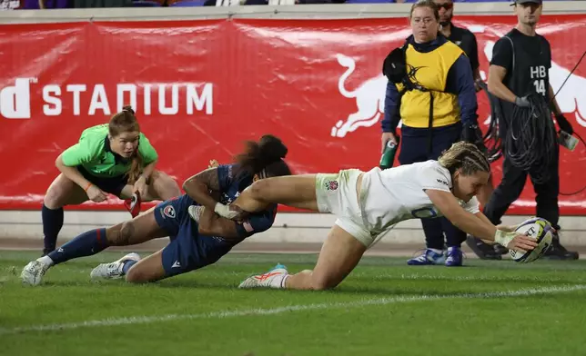England's Claudia Moloney-MacDonald, front right, scores a try against United States' Bulou Mataitoga, front left, during the second half of an international women's rugby match during the WXV Global Series, Friday, Oct. 30, 2026, in Harrison, N.J. (AP Photo/Pamela Smith)