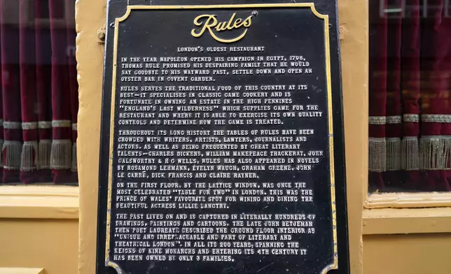 A board explaining the history stands outside London's oldest Restaurant ' Rules' which has been donated to Europe's biggest conservation charity in London, Wednesday, Oct. 14, 2026.(AP Photo/Alberto Pezzali)