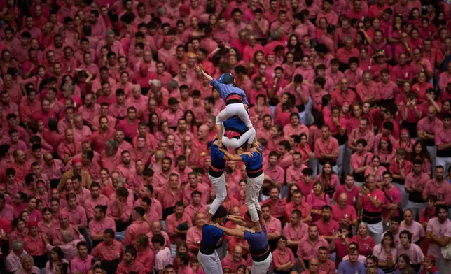 Members of Castellers Vila de Gracia form a "castell," or human tower, during the 30th Concurs de Castells, or Human Tower Competition, in Tarragona, Spain, Sunday, Oct. 4, 2026. (AP Photo/Emilio Morenatti)