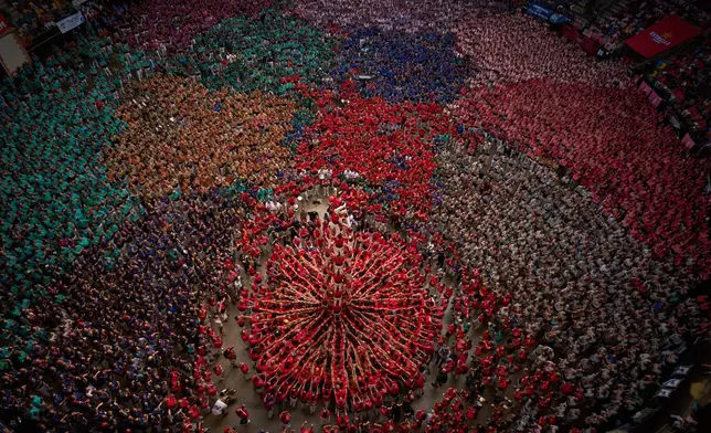 Members of Castellers Joves de Valls form a "castell," or human tower, during the 30th Concurs de Castells, or Human Tower Competition, in Tarragona, Spain, Sunday, Oct. 4, 2026. (AP Photo/Emilio Morenatti)