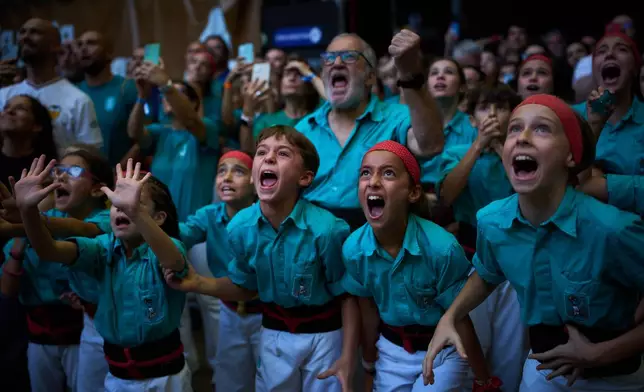 Members of Castellers Joves de Valls fall as they tried to form a "castell," or human tower, during the 30th Concurs de Castells, or Human Tower Competition, in Tarragona Spain, Sunday, Oct. 4, 2026. (AP Photo/Emilio Morenatti)