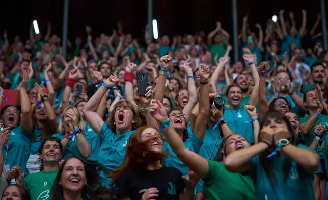 Supporters of Castellers de Vilafranca react as their team complete a "castell," or human tower, during the 30th Concurs de Castells, or Human Tower Competition in Tarragona, Spain, Sunday, Oct. 4, 2026. (AP Photo/Emilio Morenatti)